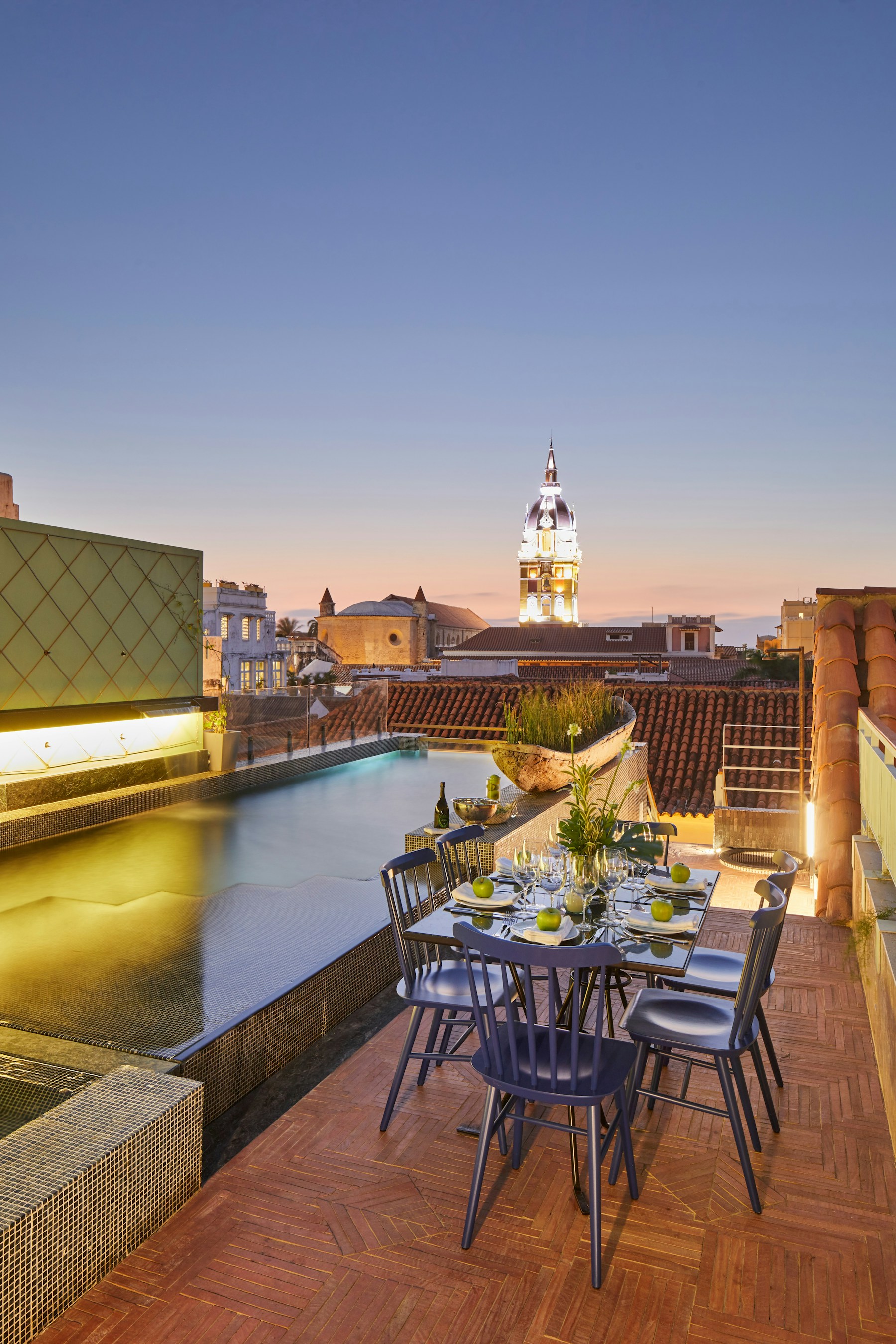 An intimate rooftop table overlooking Cartagena at dusk